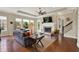 Open-concept living room featuring a fireplace, hardwood floors, and large windows for natural light at 1457 Birdsong Dr, Westfield, IN 46074