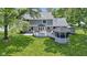 This backyard features a spacious lawn, a deck with seating, and a charming gazebo at 15120 Romalong Ln, Carmel, IN 46032