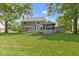 Expansive backyard view of the lawn, deck, gazebo, and siding of the home at 15120 Romalong Ln, Carmel, IN 46032