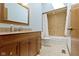 Bright bathroom featuring a vanity, a mirror, granite countertops, and a tiled shower with a bathtub at 15120 Romalong Ln, Carmel, IN 46032