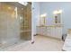 Modern bathroom with glass shower, granite countertops, and dual sinks at 15120 Romalong Ln, Carmel, IN 46032