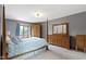 Bedroom with a four-poster bed, gray walls, carpet, and natural light from the window at 15120 Romalong Ln, Carmel, IN 46032