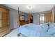 Bright primary bedroom featuring neutral carpet, four-poster bed, and access to en-suite bath and walk-in closet at 15120 Romalong Ln, Carmel, IN 46032