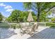 Outdoor wooden deck features patio table with seating to enjoy the view of the backyard at 15120 Romalong Ln, Carmel, IN 46032