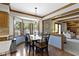 Dining area with hardwood floors, wainscotting, large bay window, and decorative chandelier at 15120 Romalong Ln, Carmel, IN 46032