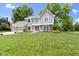 Charming two-story home boasts a well-manicured lawn, attached garage, and inviting front entrance at 15120 Romalong Ln, Carmel, IN 46032