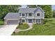 Charming two-story home featuring a manicured lawn, brick accents, and a welcoming blue front door at 15120 Romalong Ln, Carmel, IN 46032