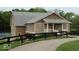 Charming exterior with stone accents, inviting porch, and well-maintained landscaping at 15120 Romalong Ln, Carmel, IN 46032