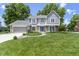 Well-maintained two-story home with a lush green lawn and mature trees providing ample shade at 15120 Romalong Ln, Carmel, IN 46032