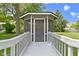 Screened gazebo accessible by wooden walkway featuring a doorway at 15120 Romalong Ln, Carmel, IN 46032