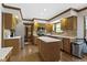 Spacious kitchen with modern stainless steel appliances, wooden cabinets, and tile backsplash at 15120 Romalong Ln, Carmel, IN 46032