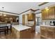 Open kitchen layout with wooden cabinets and an island for food prep at 15120 Romalong Ln, Carmel, IN 46032