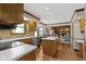 Open kitchen design with an island and view into the dining and living areas at 15120 Romalong Ln, Carmel, IN 46032