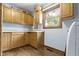 Practical laundry room with ample cabinet space, countertops, and wood-look flooring at 15120 Romalong Ln, Carmel, IN 46032