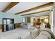 Living room showcasing ceiling beams and providing access to the kitchen at 15120 Romalong Ln, Carmel, IN 46032