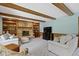Comfortable living room featuring a brick fireplace with wooden beam ceiling at 15120 Romalong Ln, Carmel, IN 46032