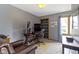 Home office featuring a large desk, multiple monitors, built-in bookshelves, and a comfortable leather chair at 15120 Romalong Ln, Carmel, IN 46032