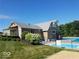 Community pool area with a pool, baby pool, sundeck, and surrounding landscaping at 15120 Romalong Ln, Carmel, IN 46032