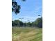 Community tennis courts bordered by fencing and trees offer an active lifestyle at 15120 Romalong Ln, Carmel, IN 46032
