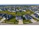 A neighborhood view showing a gray home in a suburban community with green lawns at 15736 Conductors Dr, Westfield, IN 46074