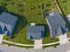 An aerial view of a home surrounded by a well-maintained lawn and backyard features at 15736 Conductors Dr, Westfield, IN 46074