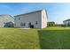 Spacious backyard features lush green grass, a patio with a grill, and well-maintained landscaping at 15736 Conductors Dr, Westfield, IN 46074