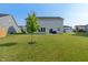 Serene backyard with healthy green grass, young trees, offering a peaceful outdoor space at 15736 Conductors Dr, Westfield, IN 46074