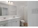 Well-lit bathroom with double sink vanity, large mirror, and a separate toilet and shower area at 15736 Conductors Dr, Westfield, IN 46074