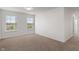 The empty bedroom has neutral carpet, is freshly painted, and has two large windows at 15736 Conductors Dr, Westfield, IN 46074