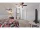 Cozy bedroom featuring a patterned quilt, ceiling fan, and decorative bird shelving for a touch of whimsy at 15736 Conductors Dr, Westfield, IN 46074