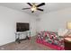Bright bedroom showcasing neutral carpet, TV on stand, and a colorful patterned quilt on the bed at 15736 Conductors Dr, Westfield, IN 46074