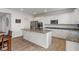 View of kitchen with white cabinets, granite countertops, stainless steel appliances, and wood flooring at 15736 Conductors Dr, Westfield, IN 46074