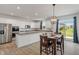 Bright kitchen with white cabinets, granite countertops, stainless steel appliances, and a dining area at 15736 Conductors Dr, Westfield, IN 46074