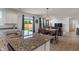 Modern kitchen featuring granite countertops, stainless steel sink, and an open view to the living area at 15736 Conductors Dr, Westfield, IN 46074
