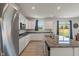 Kitchen featuring white cabinets, stainless steel appliances, granite countertops, and a view to the backyard at 15736 Conductors Dr, Westfield, IN 46074