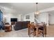 Open-concept living room featuring stylish lighting, a large brown leather sofa, and light wood flooring at 15736 Conductors Dr, Westfield, IN 46074