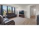 Comfortable living room with dark leather reclining sofas, large windows, and neutral-toned carpet at 15736 Conductors Dr, Westfield, IN 46074