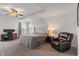 The main bedroom includes a ceiling fan, chair, desk, and large upholstered headboard at 15736 Conductors Dr, Westfield, IN 46074