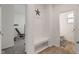 Inviting mudroom area with convenient hooks, bench seating, and access to a powder room at 15736 Conductors Dr, Westfield, IN 46074