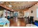 Spacious finished basement with exposed rafters and hardwood floors. Features space for both recreation and relaxation at 16307 Stony Ridge Dr, Noblesville, IN 46060