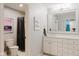 A well-lit bathroom featuring a white vanity, a large mirror, and a shower with modern finishes at 16307 Stony Ridge Dr, Noblesville, IN 46060