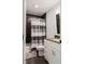 A modern bathroom with a black-tiled shower, a white vanity, and contemporary fixtures at 16307 Stony Ridge Dr, Noblesville, IN 46060
