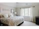 A cozy bedroom with a bright window and a comfortable-looking bed with a patterned comforter at 16307 Stony Ridge Dr, Noblesville, IN 46060