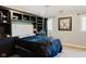 A bedroom with a built-in bookshelf, a comfortable bed, and lots of natural light at 16307 Stony Ridge Dr, Noblesville, IN 46060