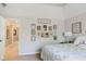 A serene bedroom with neutral colors, a decorative gallery wall, and a plush, inviting bed at 16307 Stony Ridge Dr, Noblesville, IN 46060