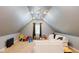 A spacious bonus room with three ceiling fans, a window, and a cozy couch, perfect for play at 16307 Stony Ridge Dr, Noblesville, IN 46060