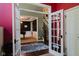 Foyer with french doors, staircase, and a view into living area with piano at 16307 Stony Ridge Dr, Noblesville, IN 46060