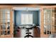 Well-lit exercise room featuring weight bench, free weights, and hardwood floors for a complete fitness experience at 16307 Stony Ridge Dr, Noblesville, IN 46060