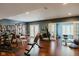 Bright home gym with various exercise equipment, hardwood floors, and natural light, promoting a healthy lifestyle at 16307 Stony Ridge Dr, Noblesville, IN 46060