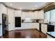 Kitchen features white cabinets, black appliances, and a breakfast bar at 16307 Stony Ridge Dr, Noblesville, IN 46060